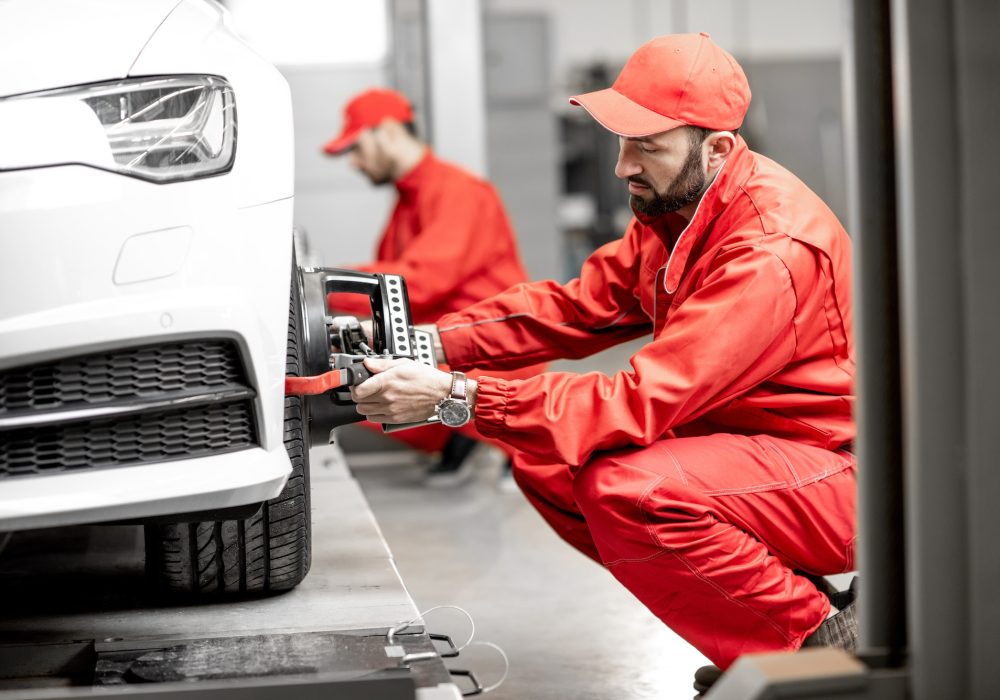 auto-mechanics-making-wheel-alignment-at-the-car-service.jpg auto-mechanics-making-wheel-alignment-at-the-car-service.jpg